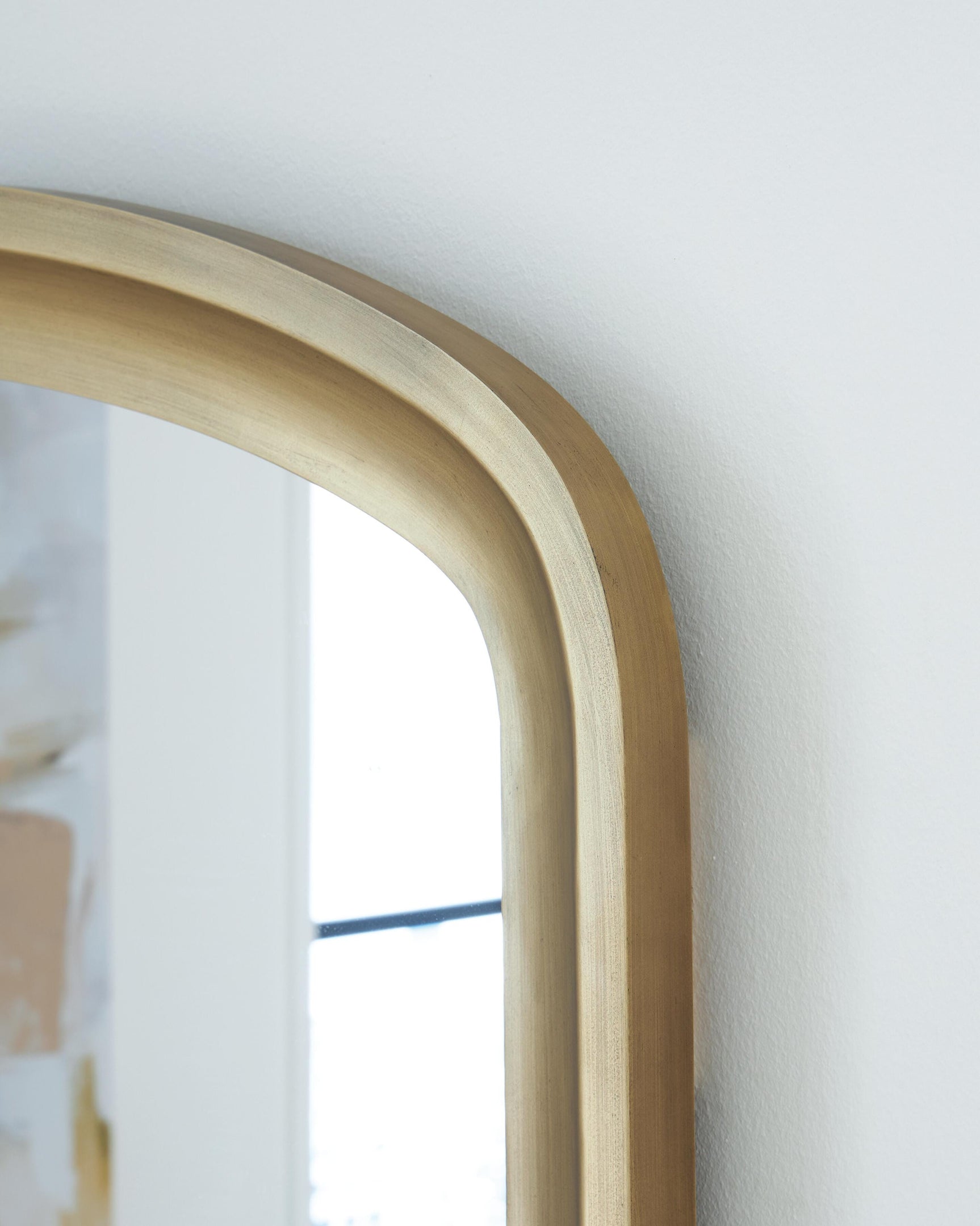 Close-up of goldtone finish detail on Fintan Floor Mirror
