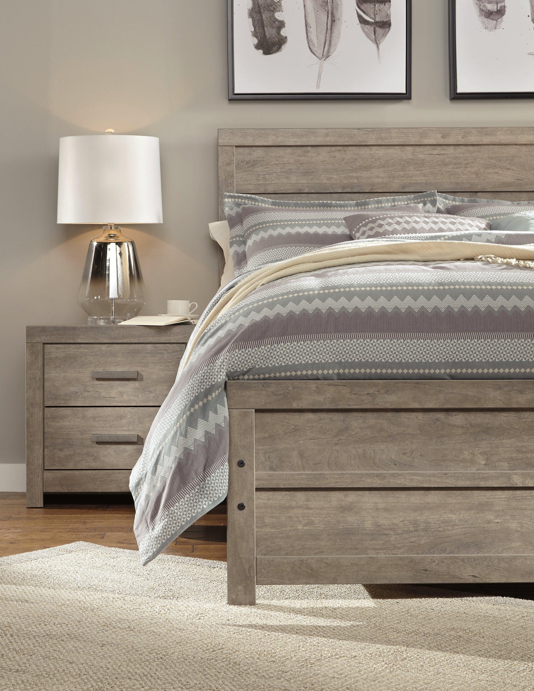 Bedroom scene with Culverbach Gray King Panel Bed and matching decor