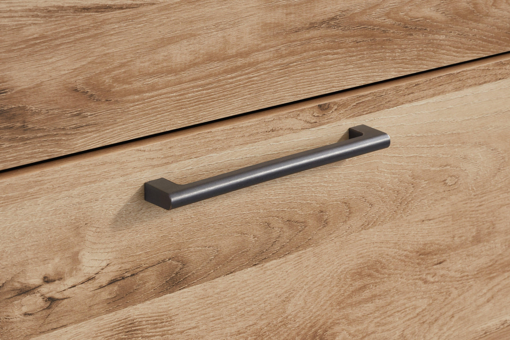 Close-up of antiqued gunmetal drawer handles on Hyanna Chest