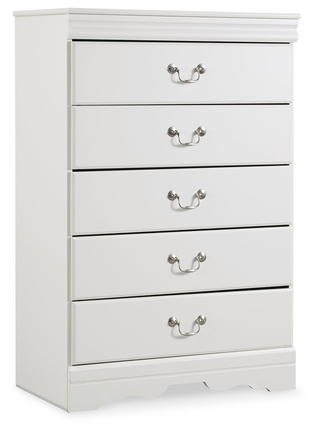 Close-up of aged pewter-tone drawer hardware on white chest
