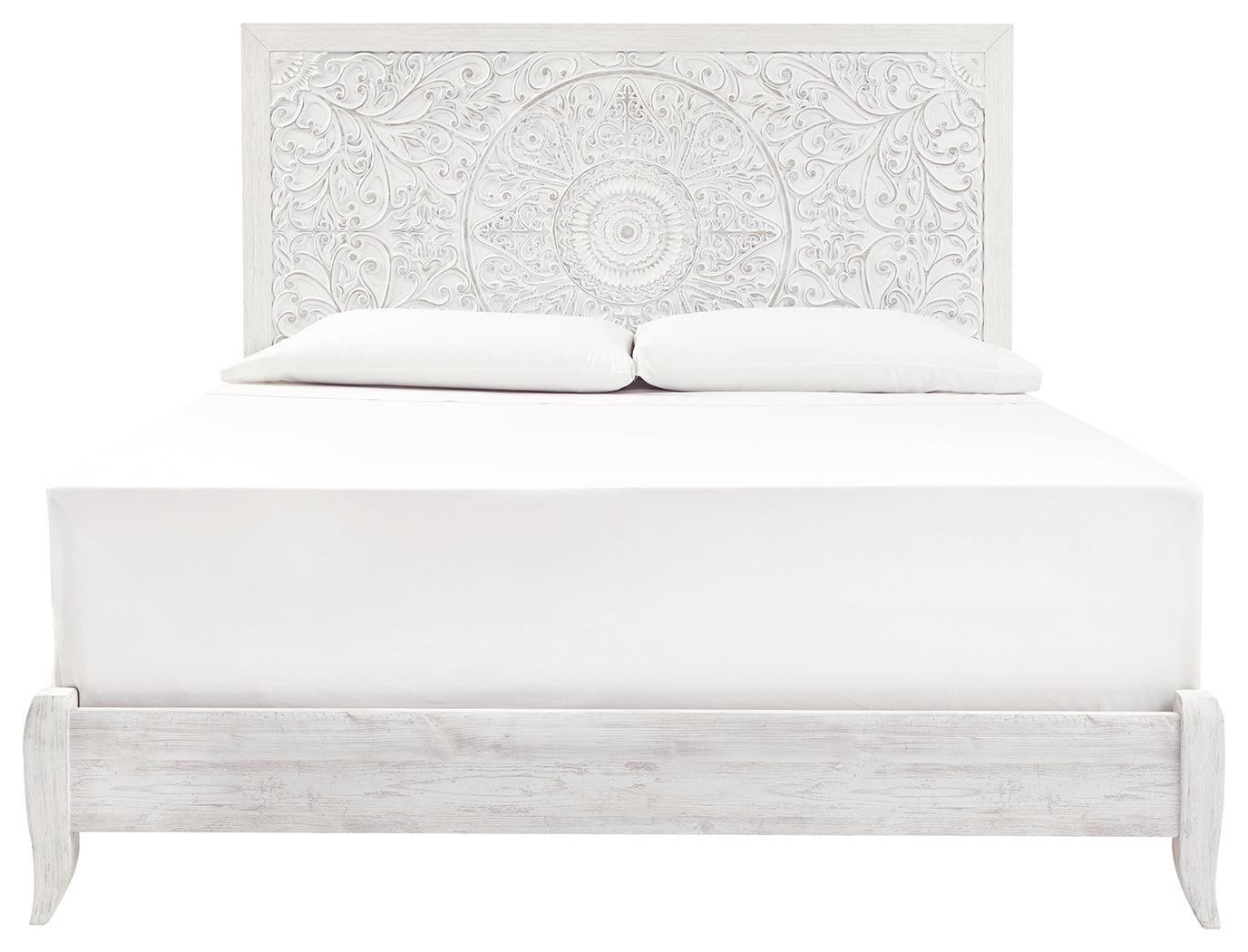 Close-up of Paxberry King Panel Bed carved medallion pattern on headboard