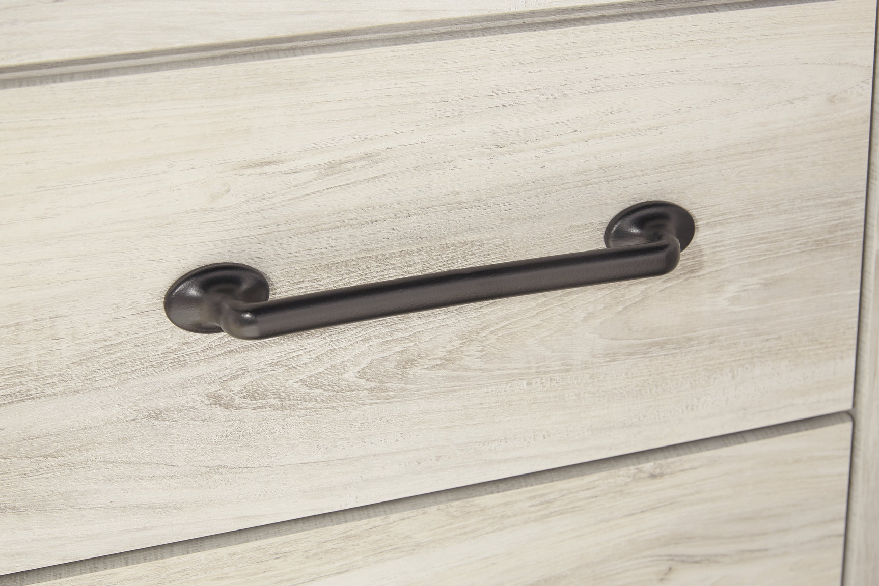 Close-up of wood grain and hardware detail on Cambeck bed