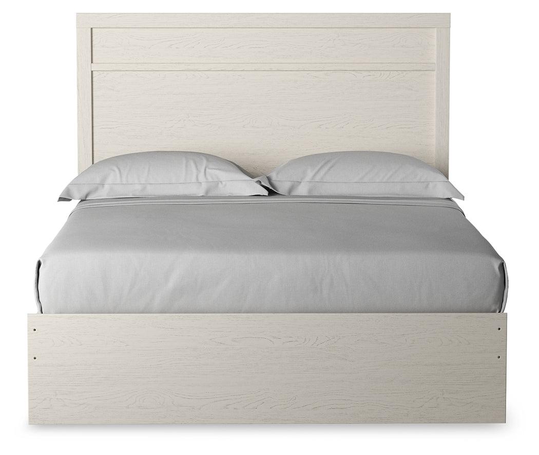 Side view of Stelsie White Queen Panel Bed highlighting storage drawers