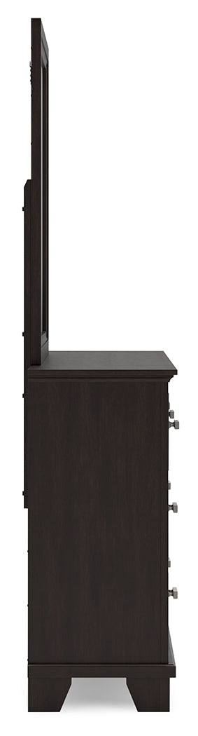Close-up of bright nickel-tone metal bar pulls on Covetown dresser