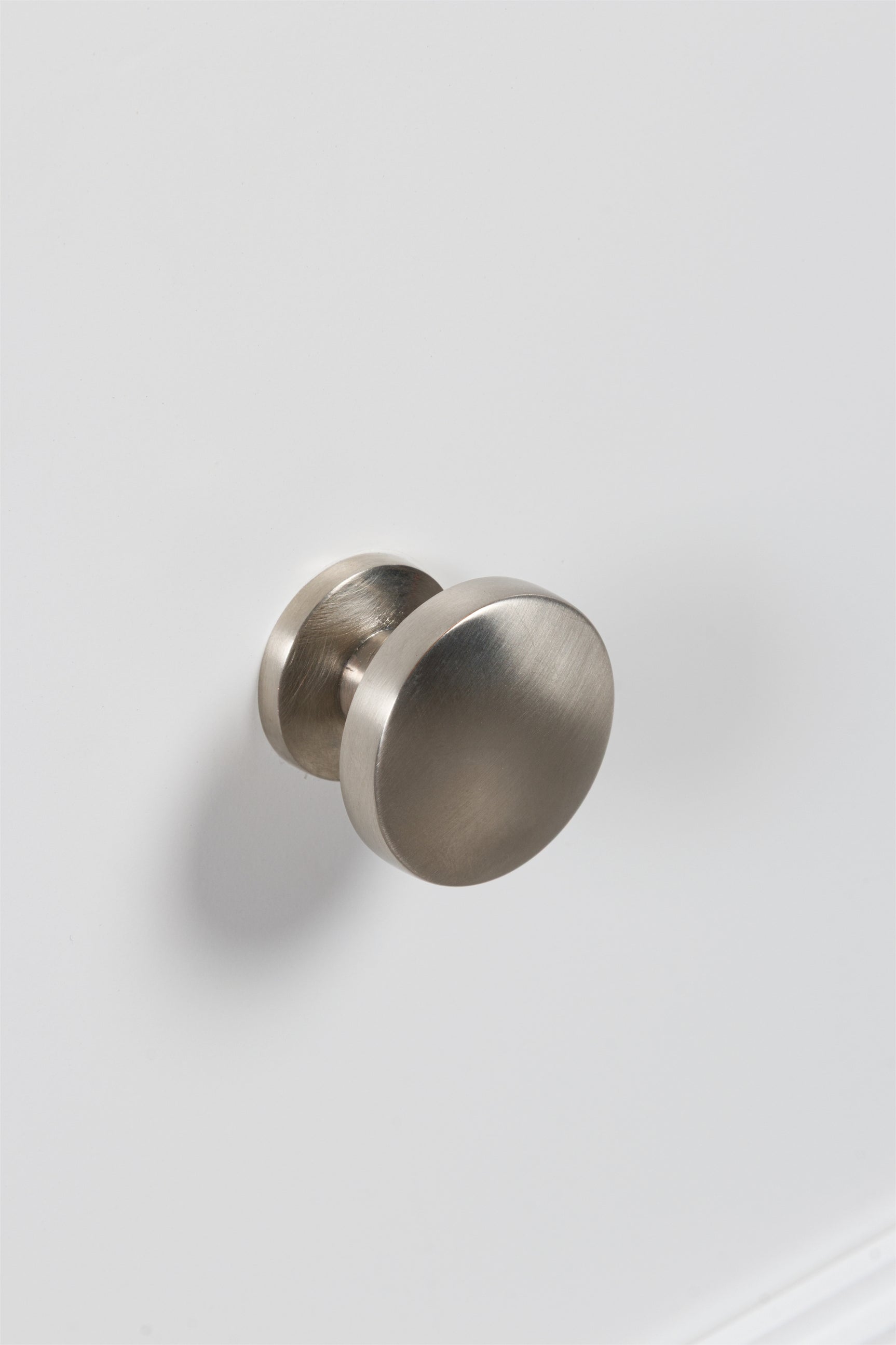 Close-up of satin nickel-tone round drawer knobs