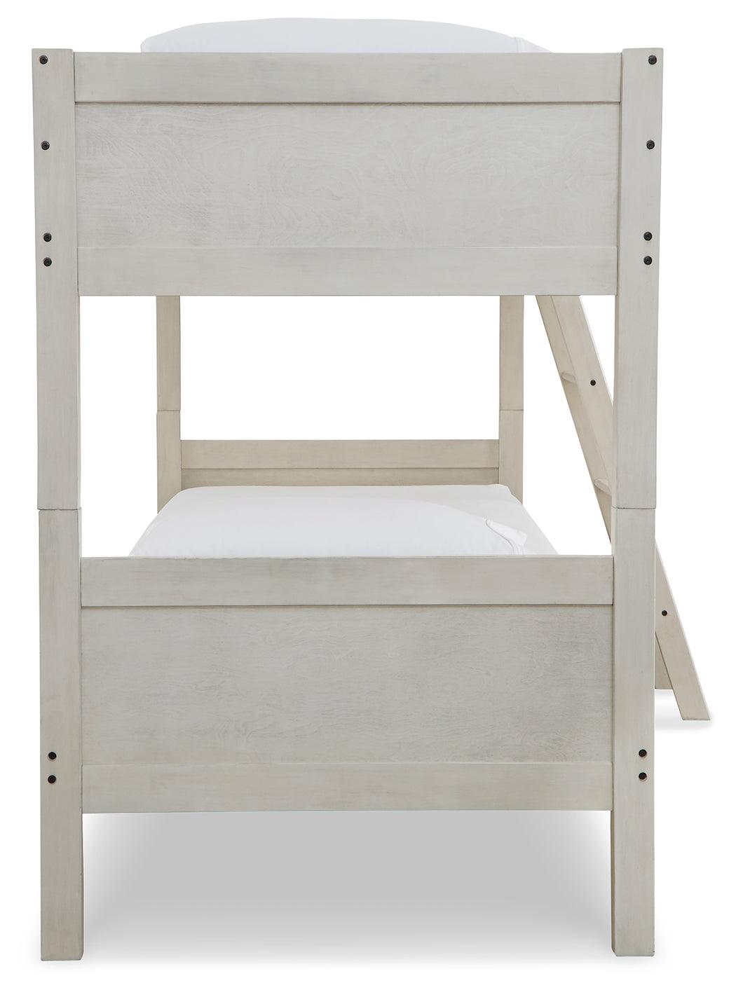 Close-up of ladder and side rails on Robbinsdale Antique White Twin-Over-Twin Bunk Bed