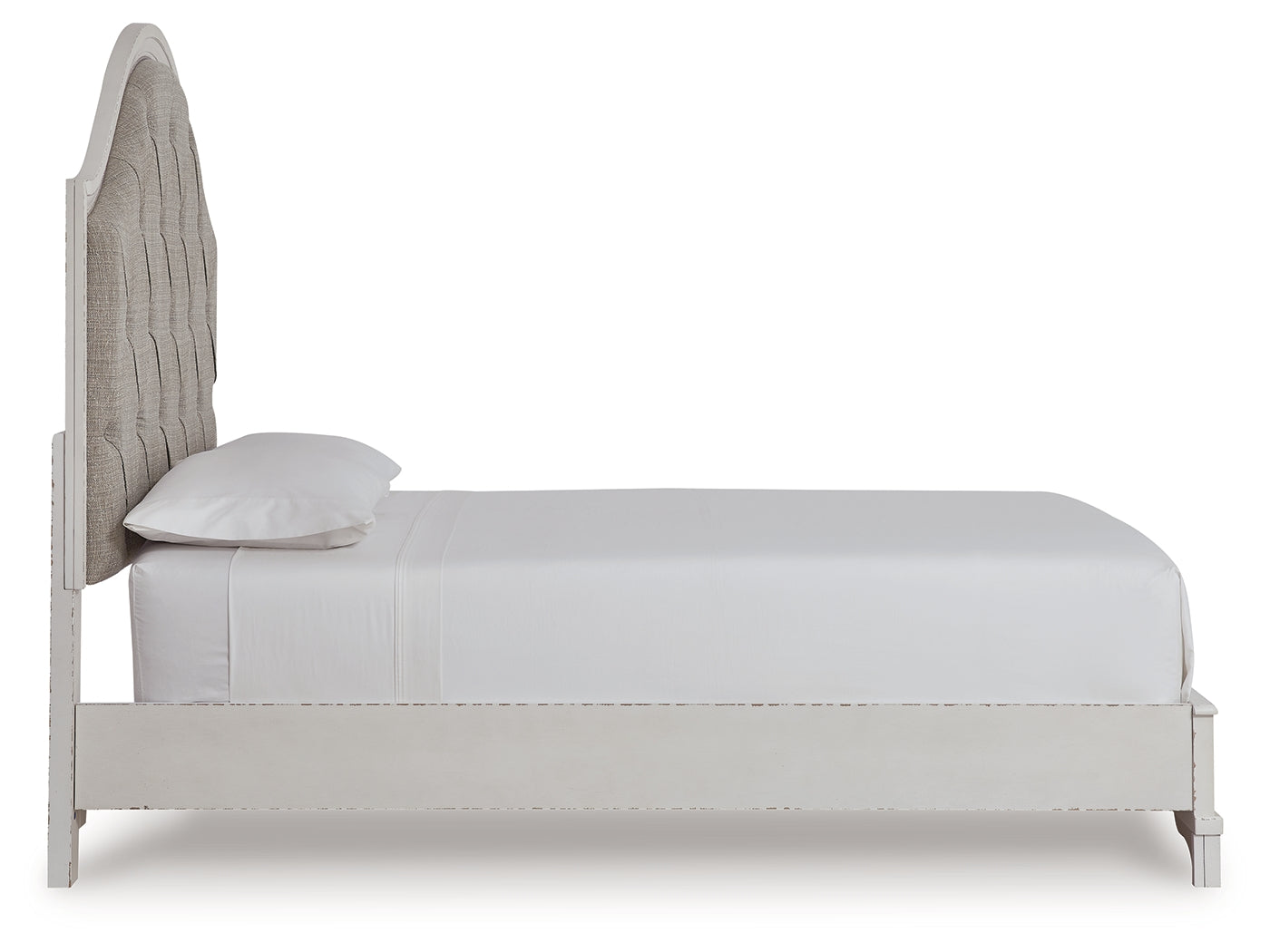 Detail of bed upholstery and rustic brown finish