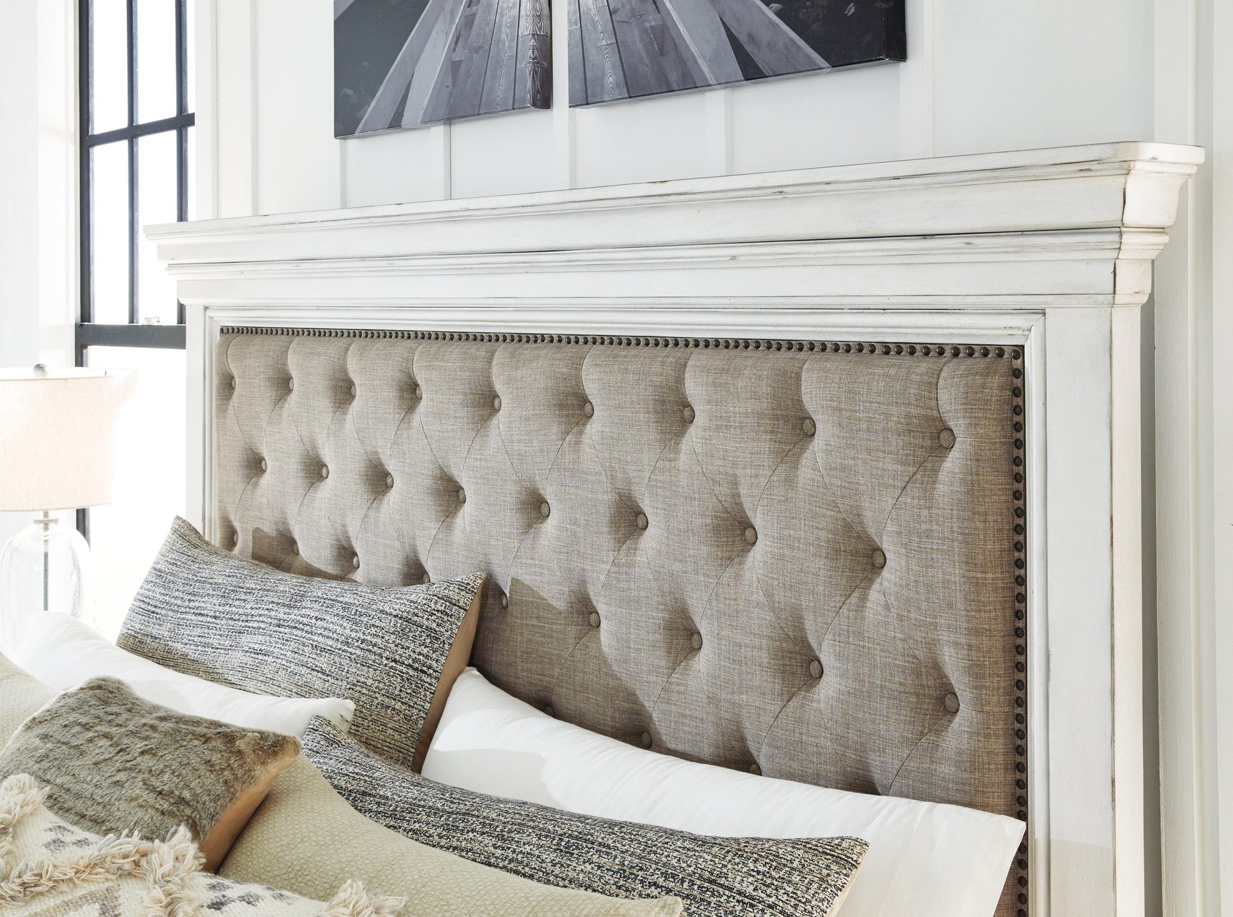 Button tufted fabric upholstery and nailhead trim detail