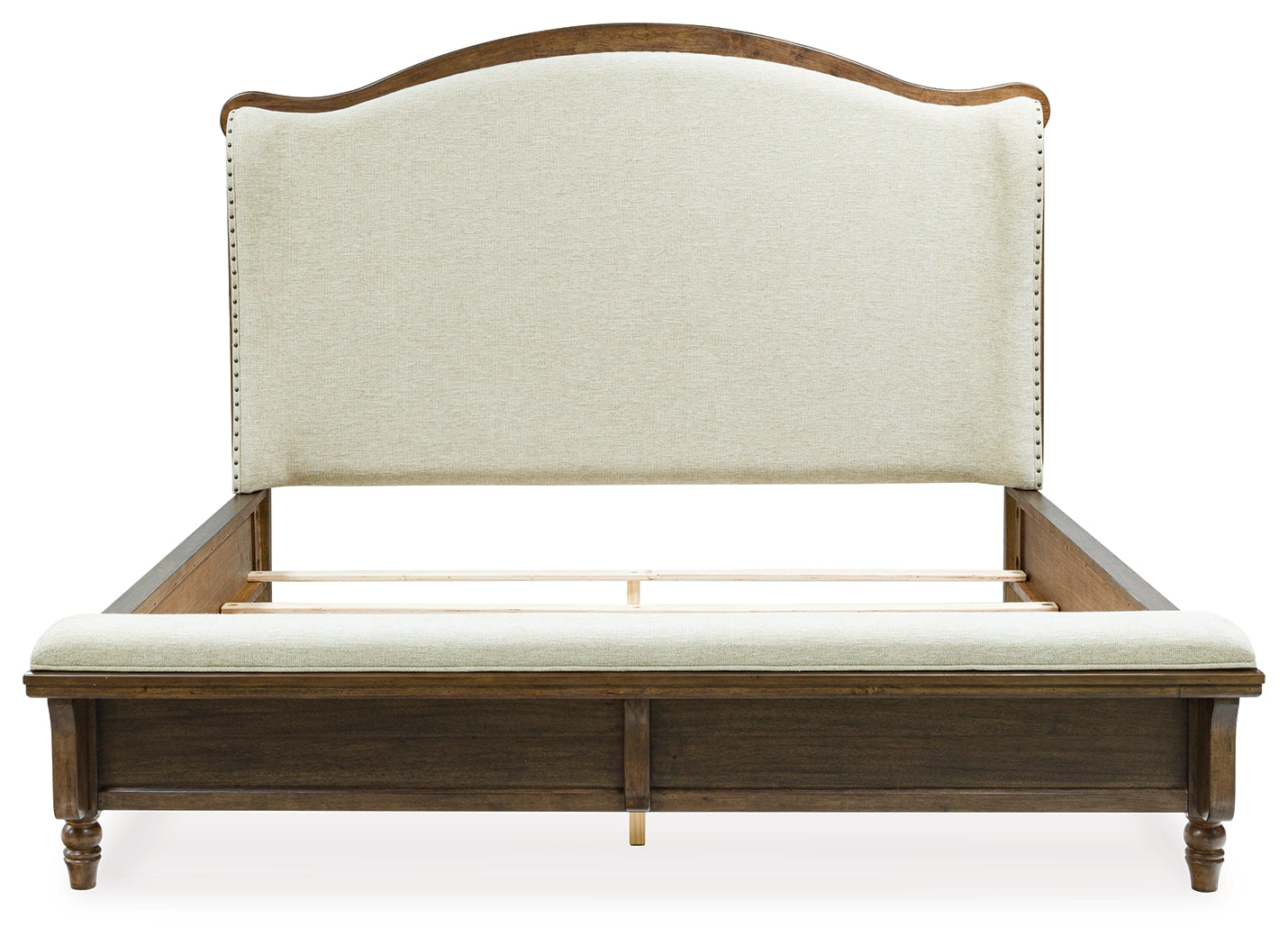 Close-up of the upholstered panel headboard with nailhead trim