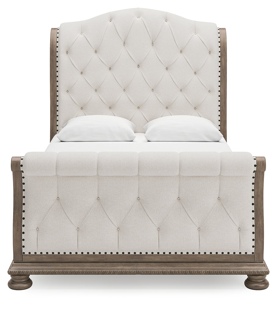 Ardenfield Queen Upholstered Sleigh Bed head-on view of tufted headboard