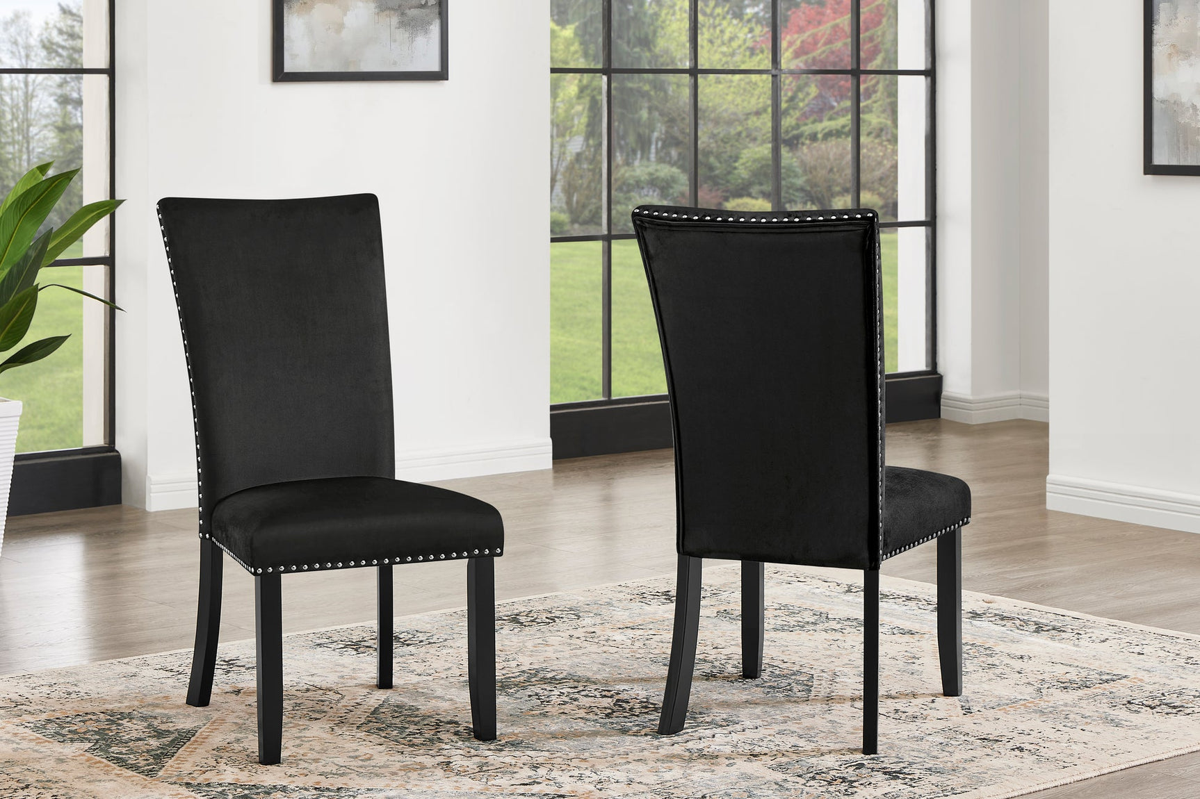 Detail view of Larry Black dining room set showing table edge and chair upholstery