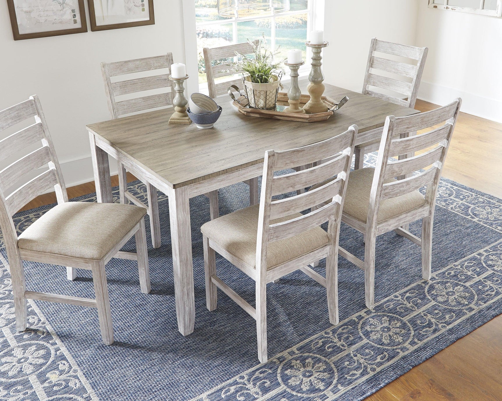 Side angle of Skempton dining set highlighting white upholstered chairs
