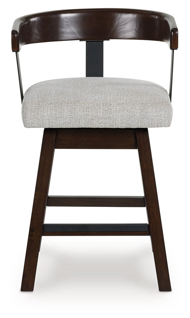 Barstool seat detail showing wood frame and fabric upholstery