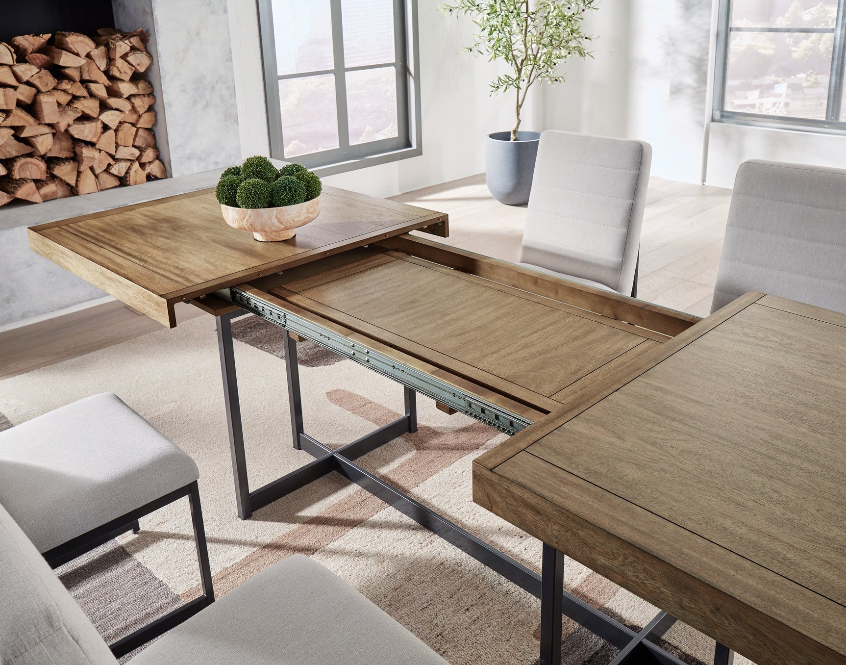Tomtyn dining table showing self-storing leaf mechanism