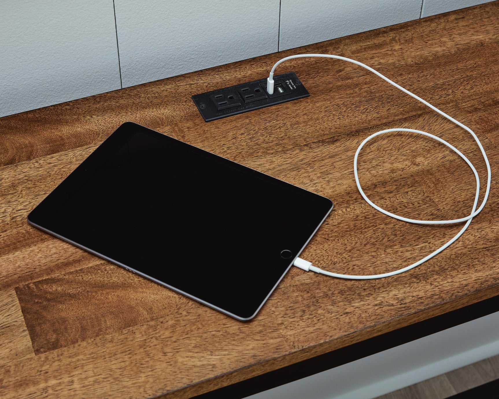 Close-up of USB charging ports built into Wildenauer dining table