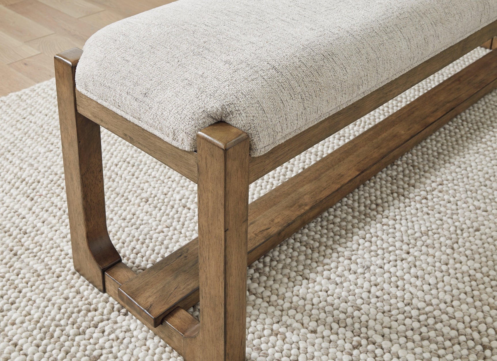 Cabalynn 63-inch dining bench with upholstered seat in oatmeal and light brown frame