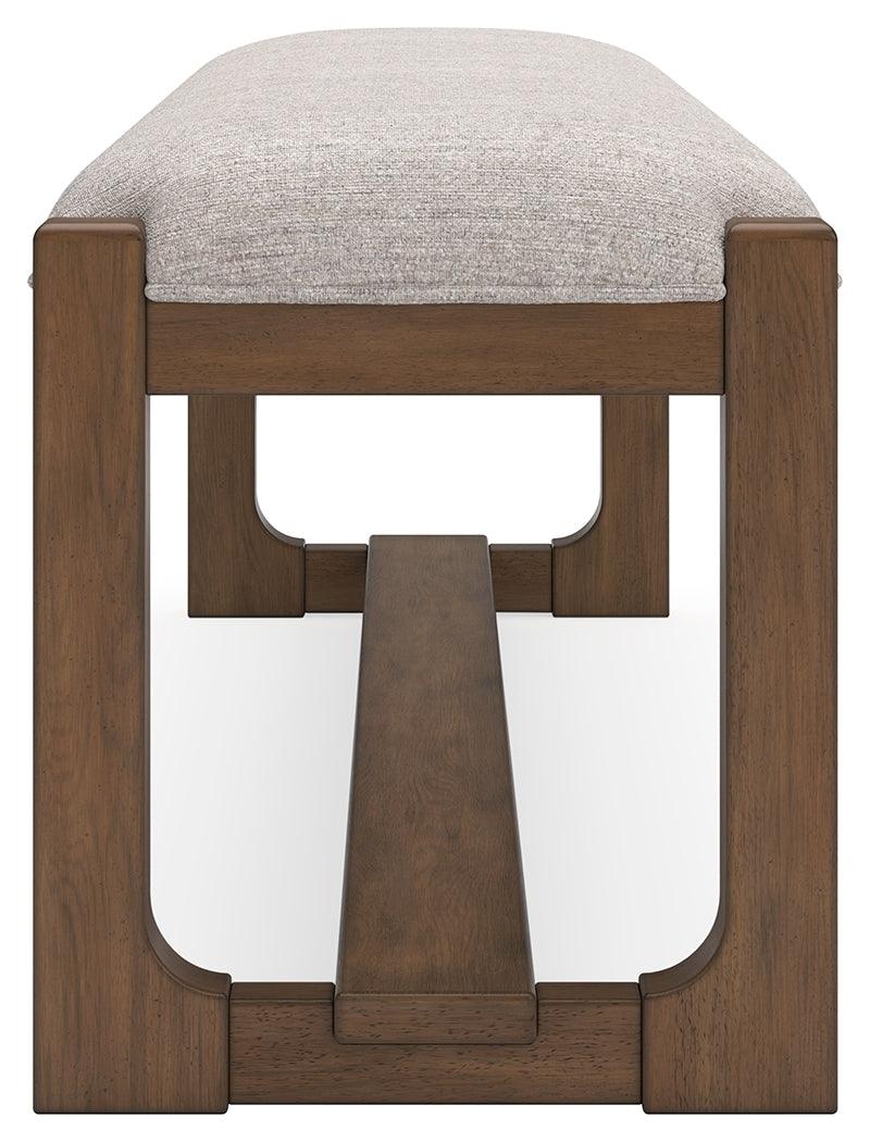 Angled image showing upholstery texture and bench legs of Cabalynn dining bench