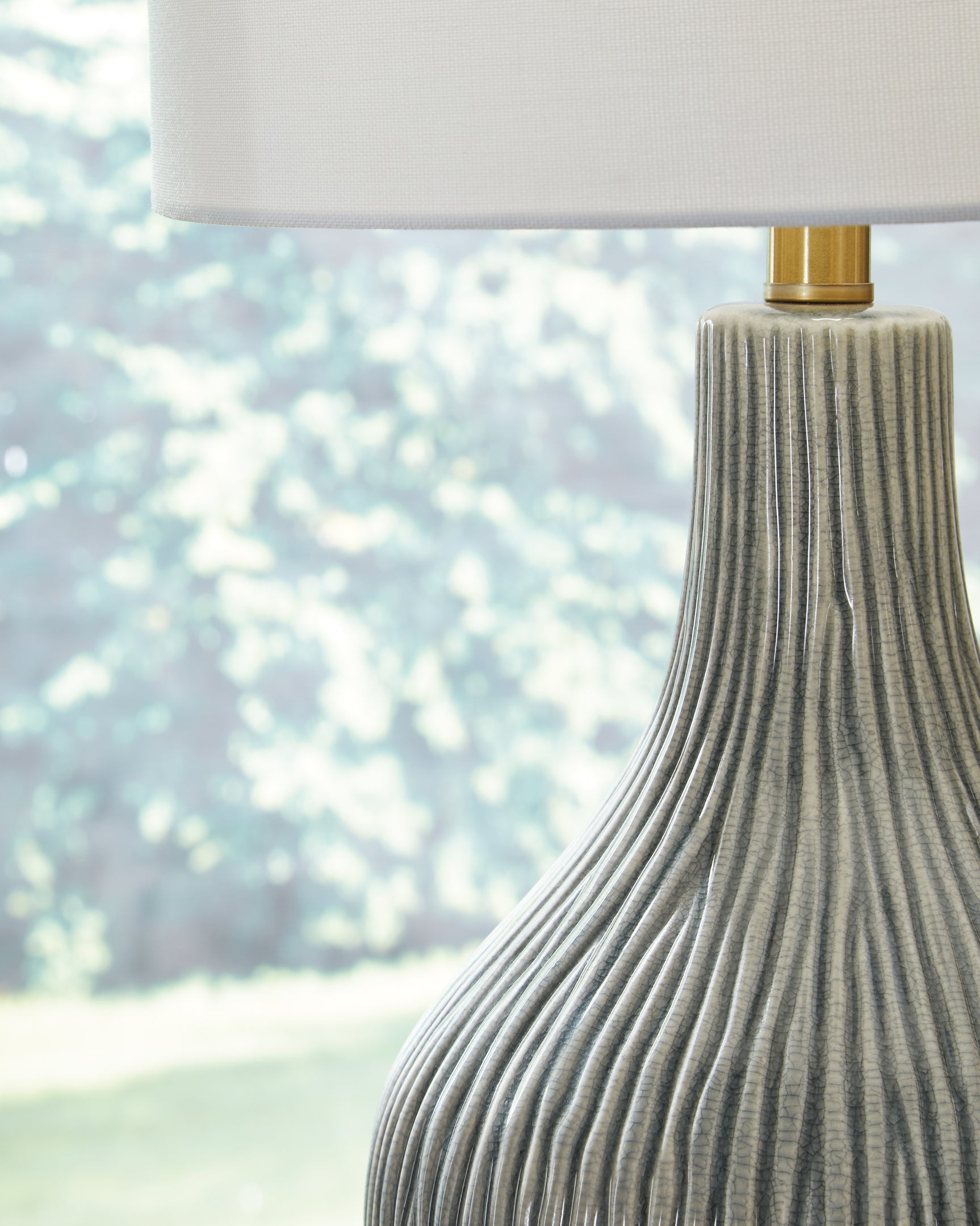 Close-up detail of Judlen lamp base with gray crackle finish and goldtone feet
