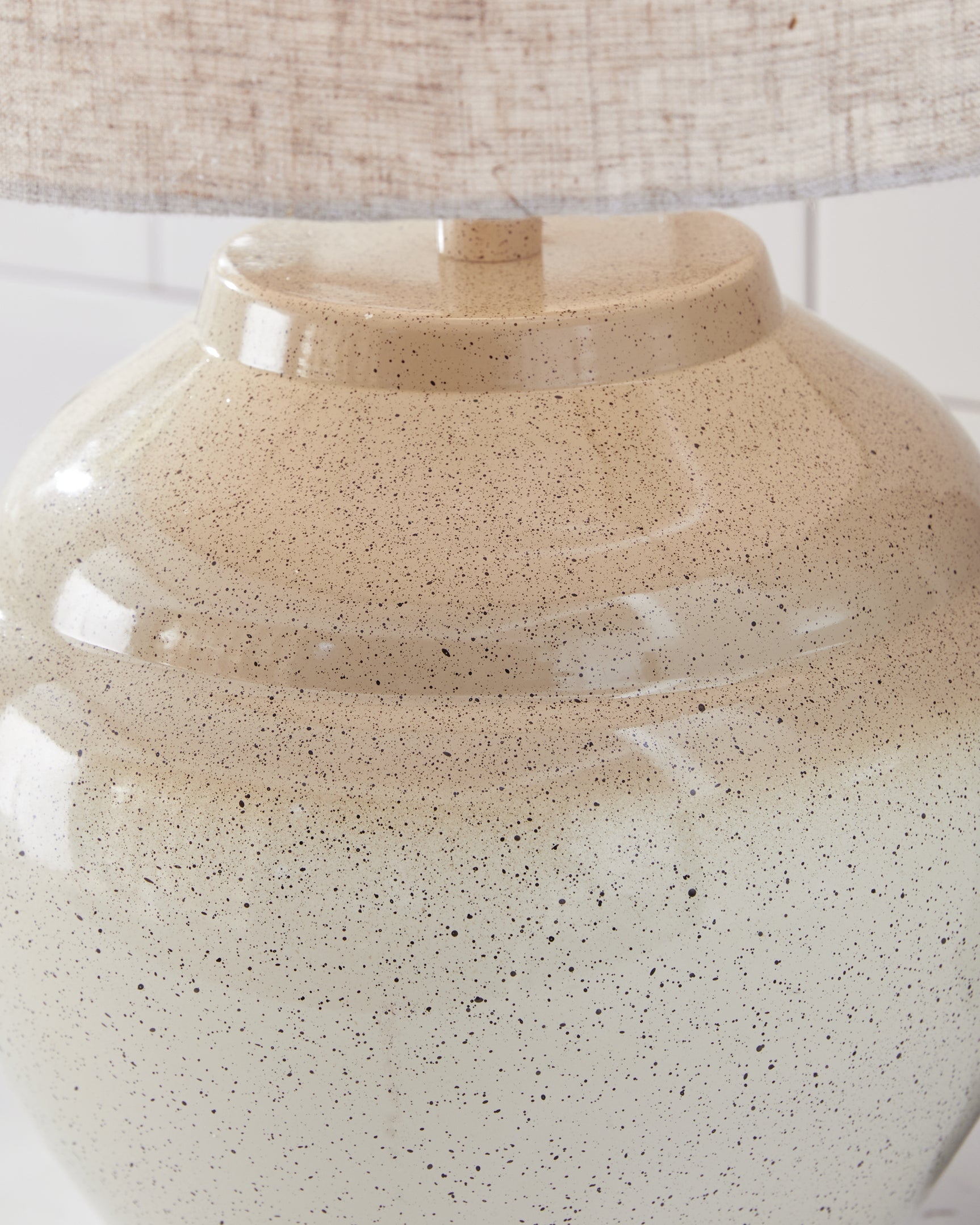 Close-up detail of Waldish lamp's fabric drum shade and metal base