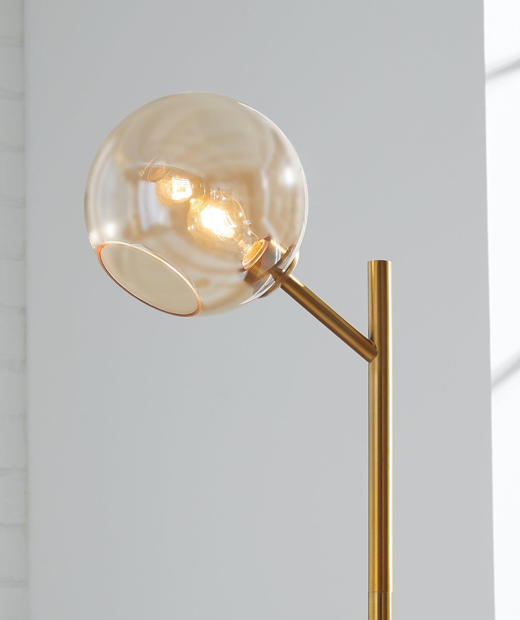 Side view of Abanson Amber gold floor lamp with adjustable neck