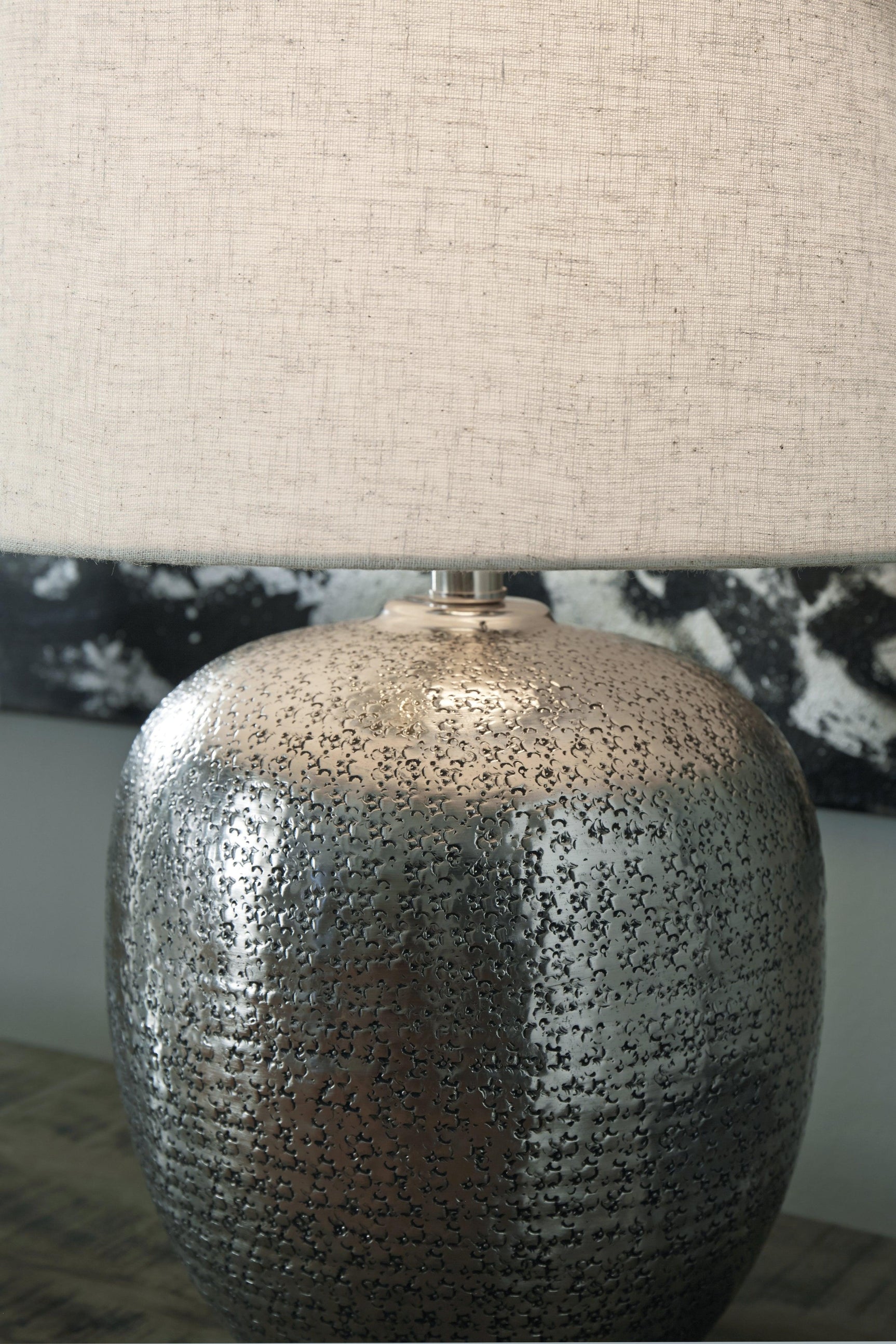 Detail of hammered aluminum texture on Magalie Table Lamp base