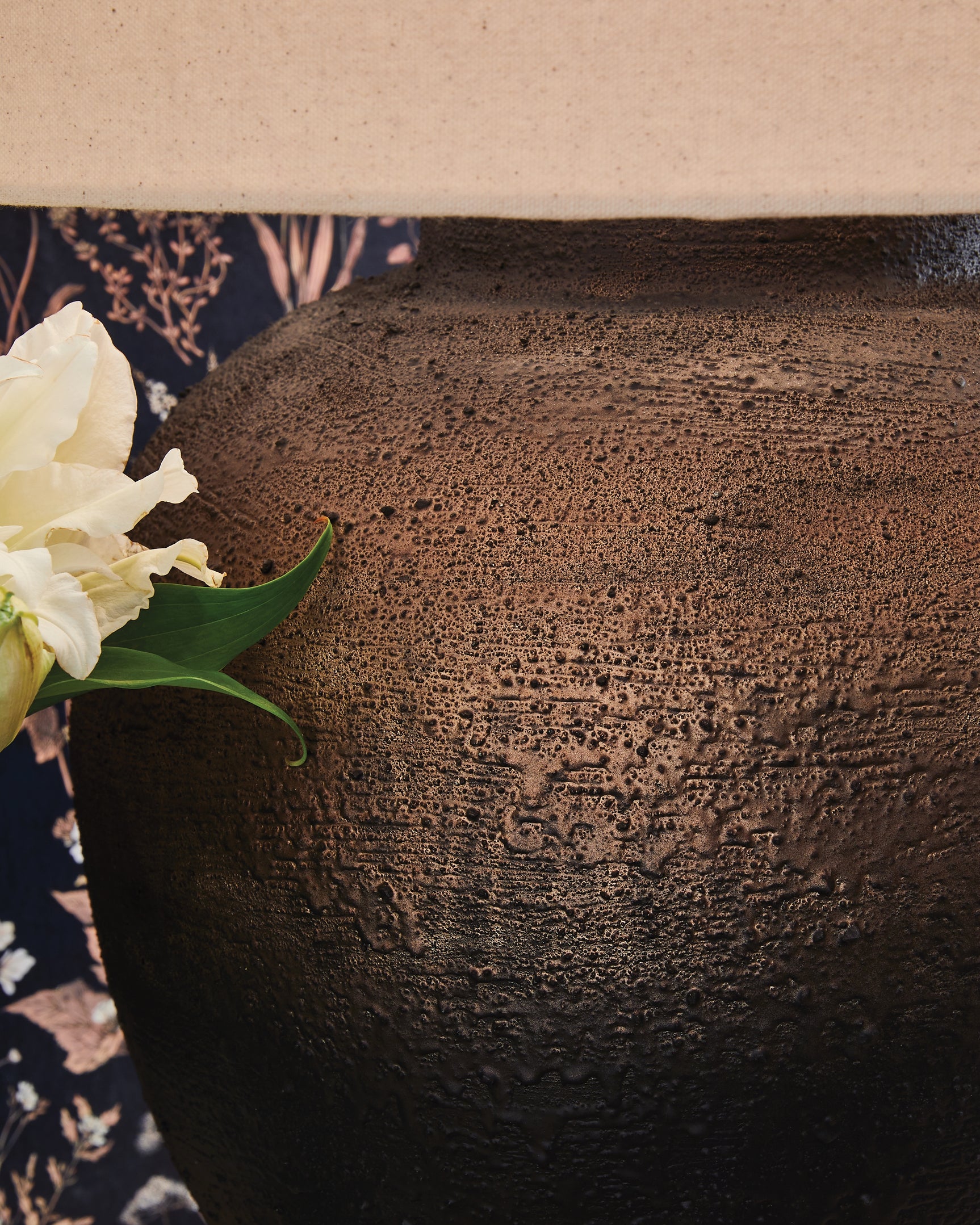 Close-up detail of textured metallic brown and black lamp base
