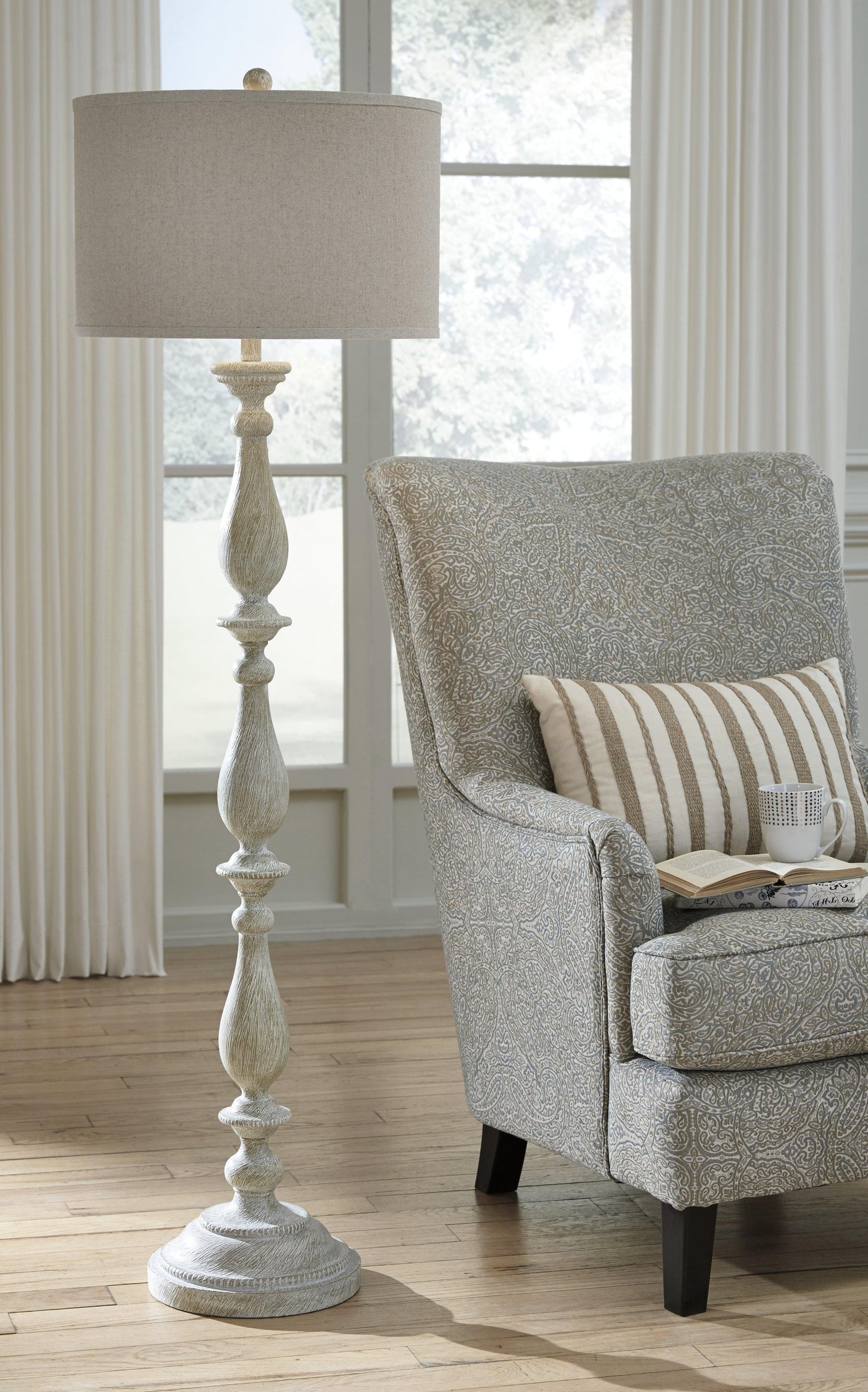 Bernadate floor lamp illuminated in a living room setting
