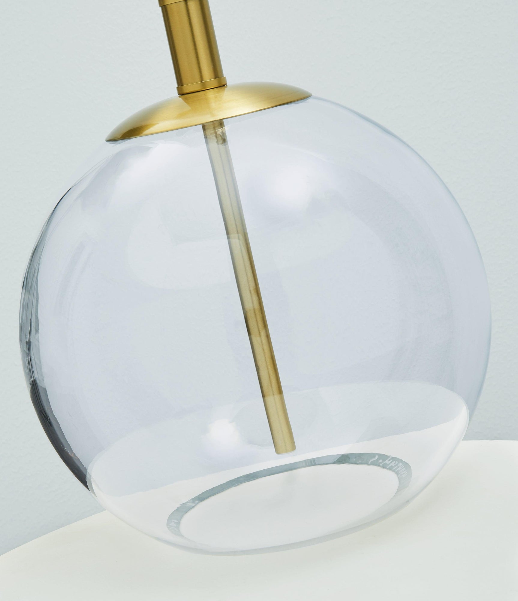 Detail of Samder lamp base showing clear glass and brass accents
