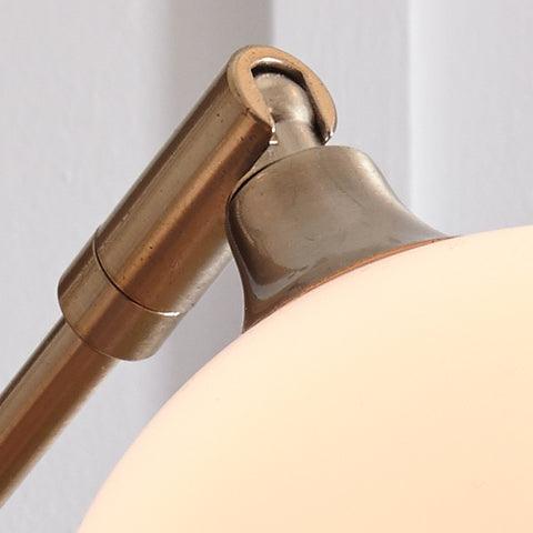 Detail of white marble base and champagne metal frame