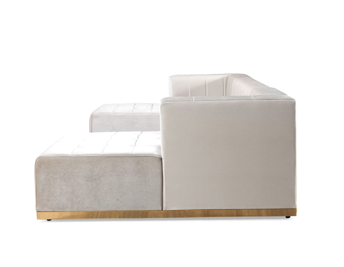 Side angle of ivory velvet sectional showing chaise design
