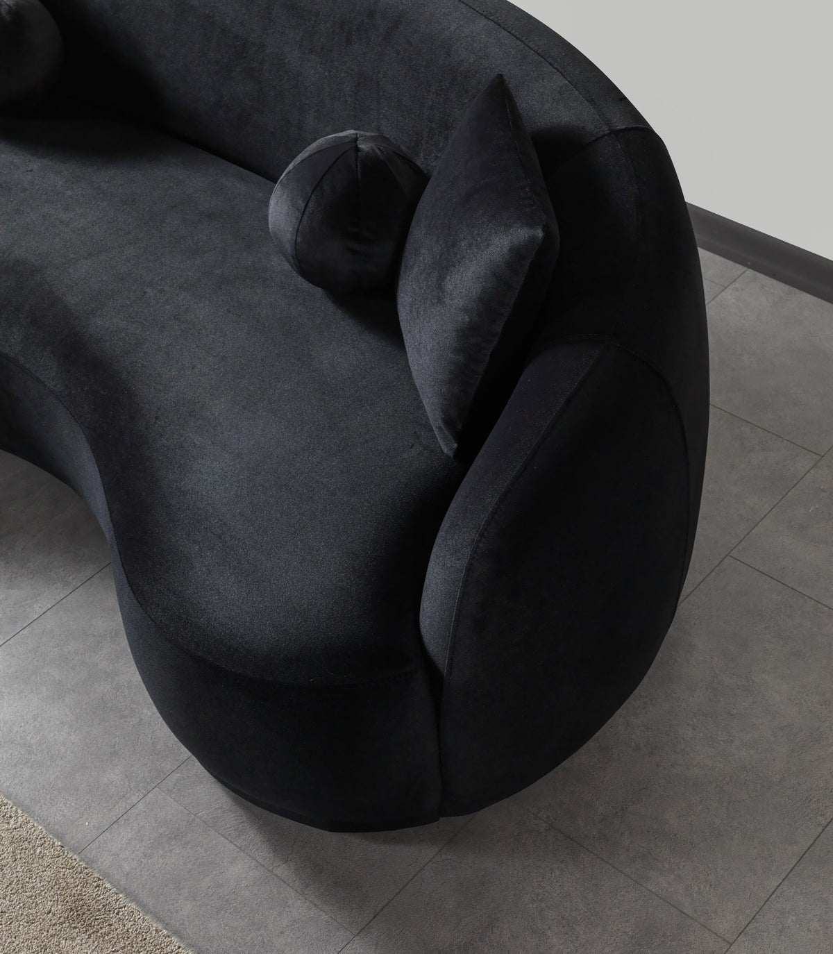 Side profile of Emily black velvet sofa