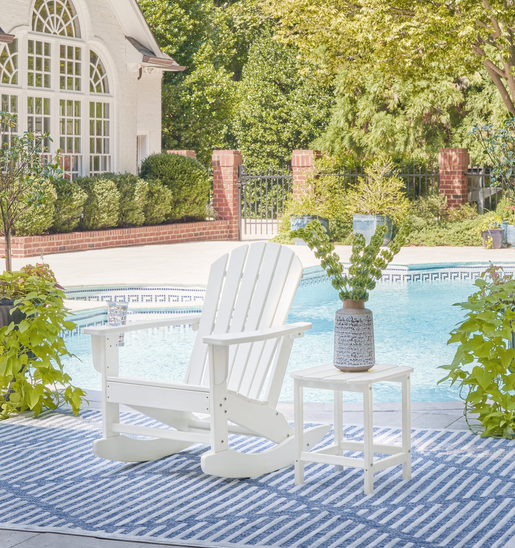 Close-up of Sundown white Adirondack chair armrest showing slatted design