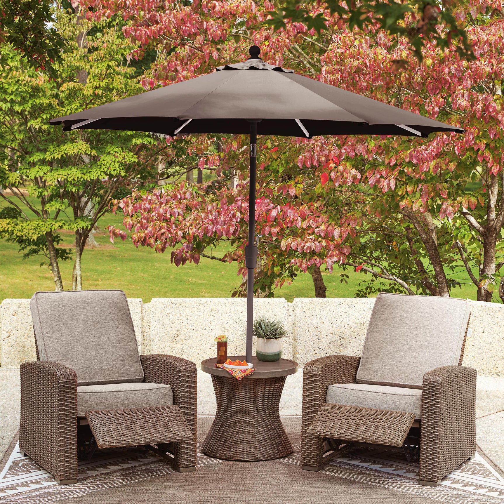 Patio set arranged with two recliners and table in beige