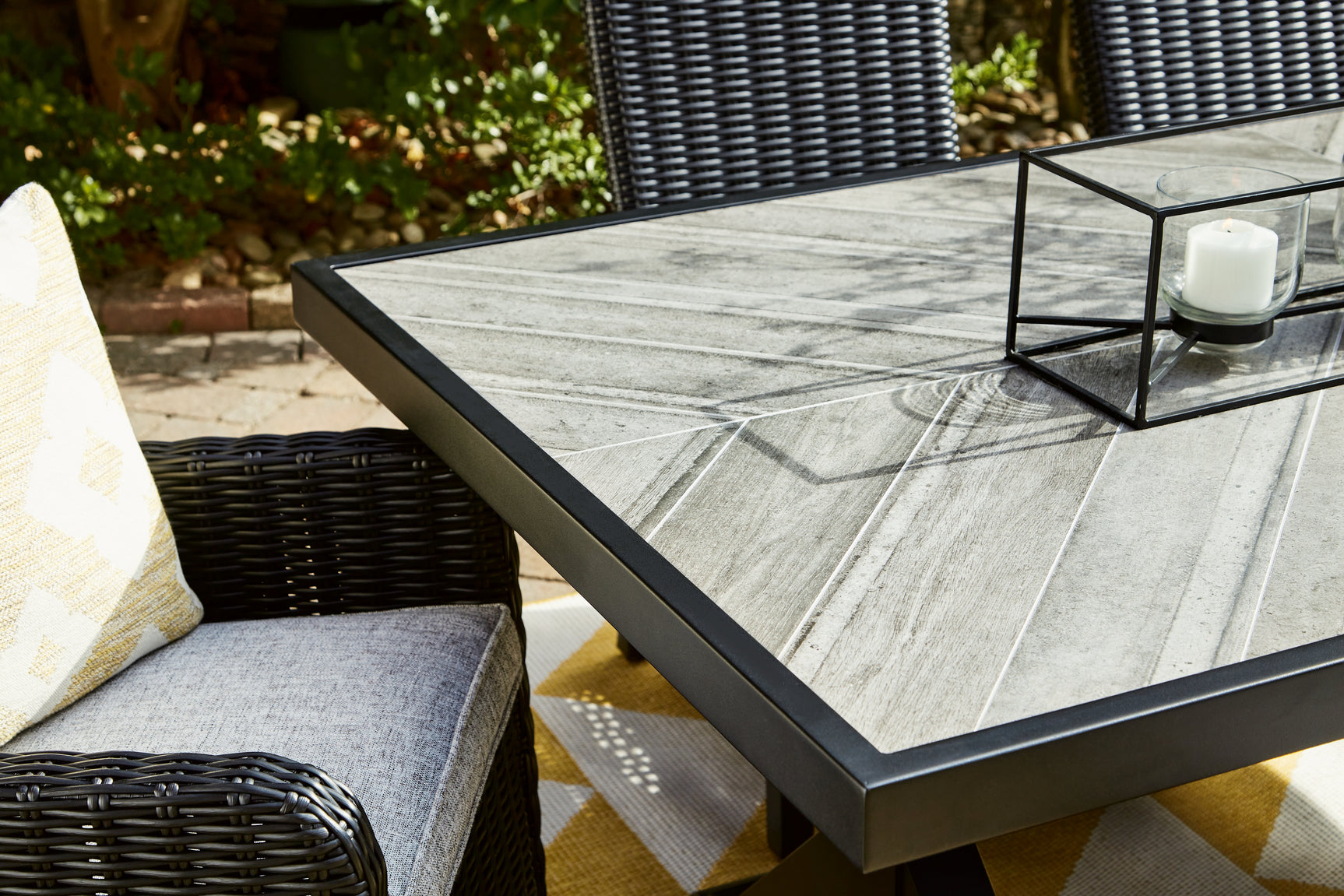 Beachcroft black and light gray outdoor dining table with four chairs