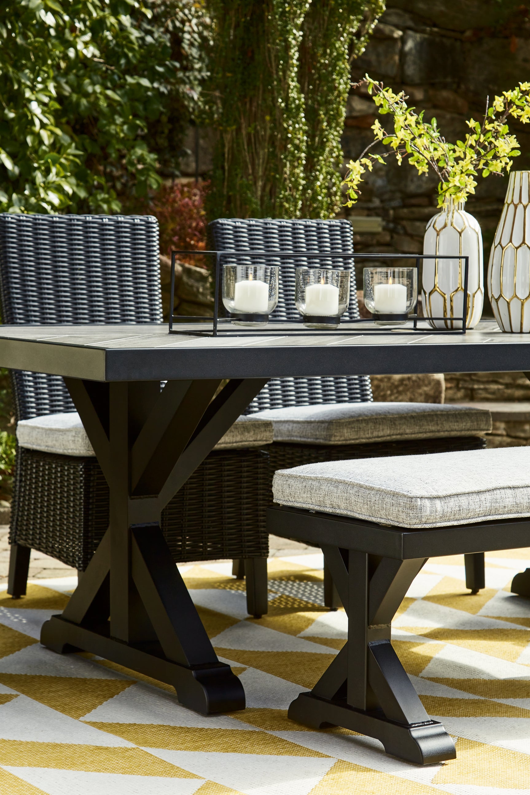 Beachcroft Outdoor Dining Table styled in outdoor setting vertical