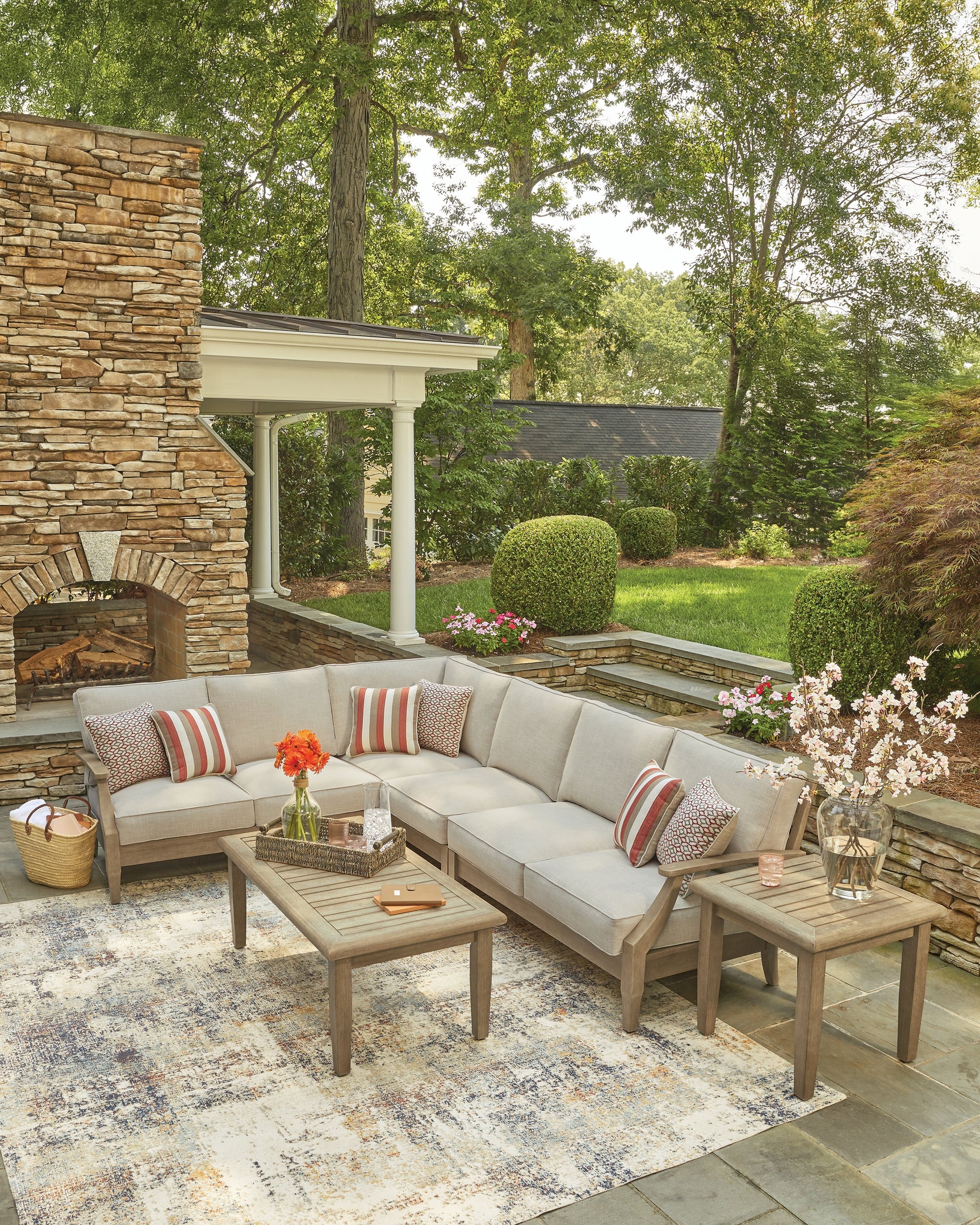Vertical mood image of Clare View beige outdoor sectional with cushions