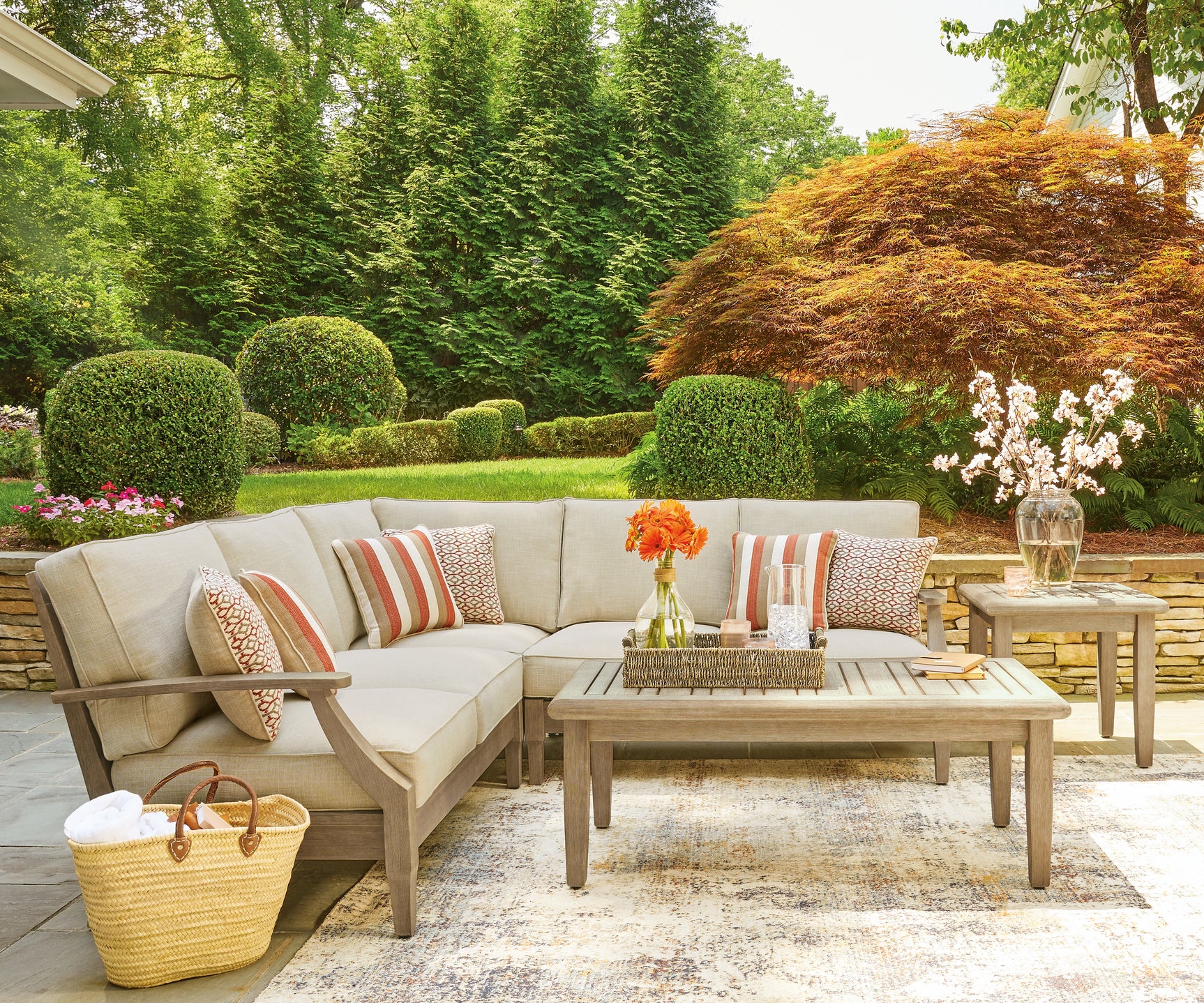 Lifestyle image of Clare View sectional set on patio showing all three pieces
