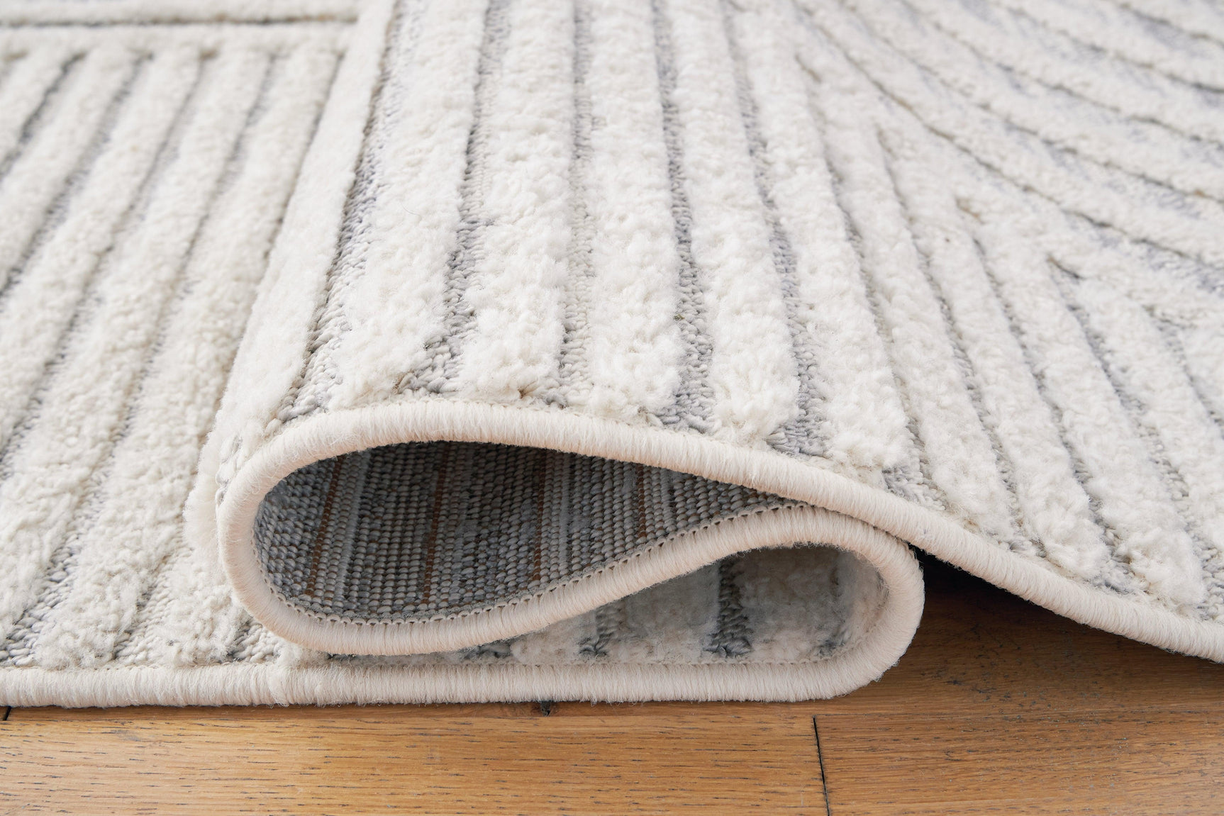 Rolled view of Lambworth Gray Cream rug