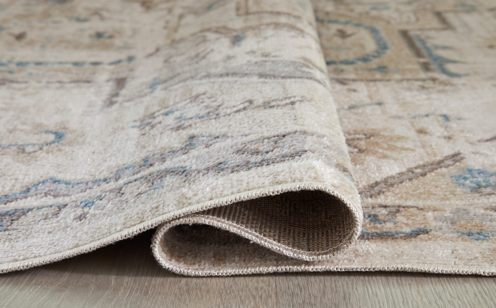 Barkham Multi rug rolled showing backside and jute backing