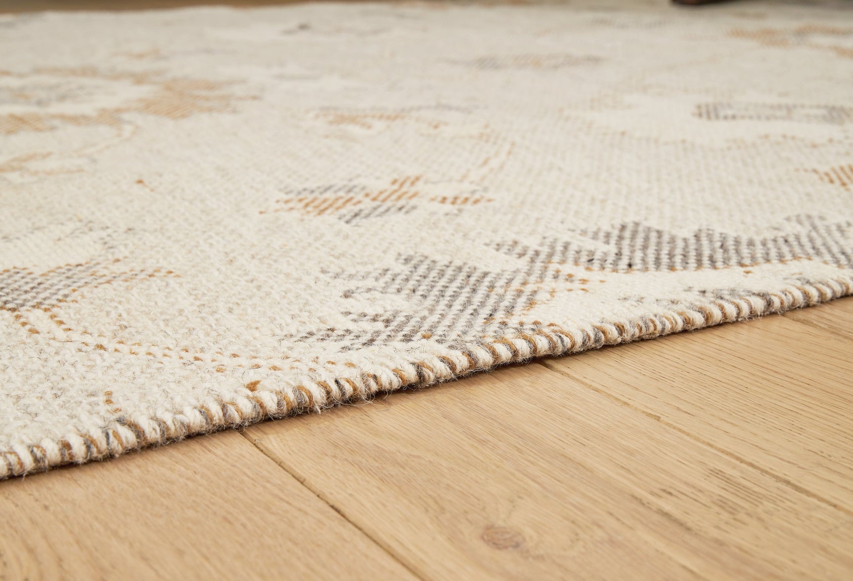 Close-up of Calkin linen gray caramel floral rug texture