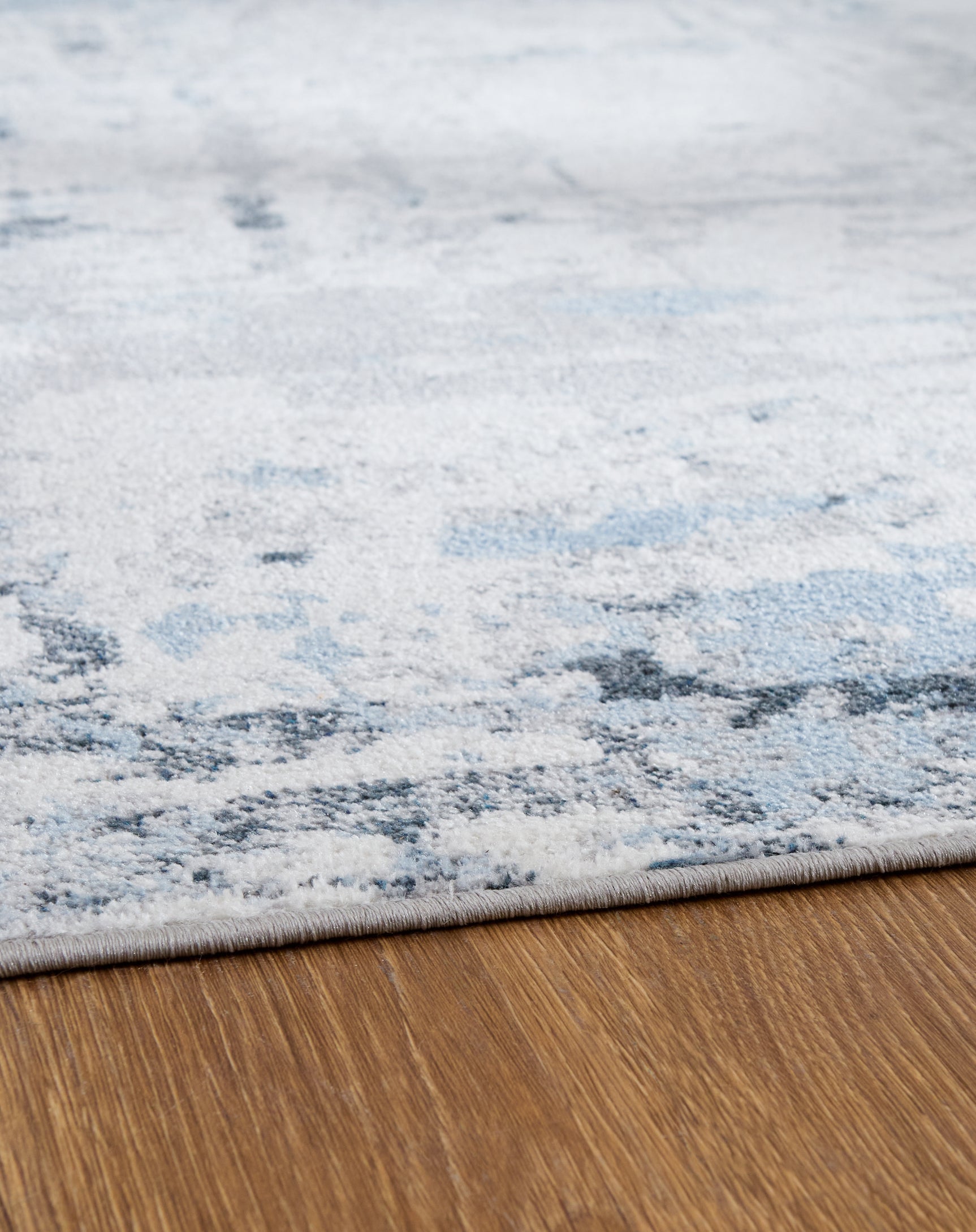 Close-up detail of Emertonly abstract blue gray pattern washable rug