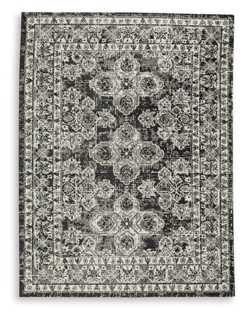 Close-up detail of Glennisman Medium Rug weave and botanical design