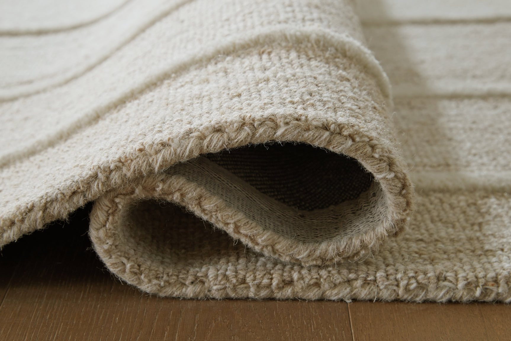 Rolled View of Teelgan Ivory Tan Rug
