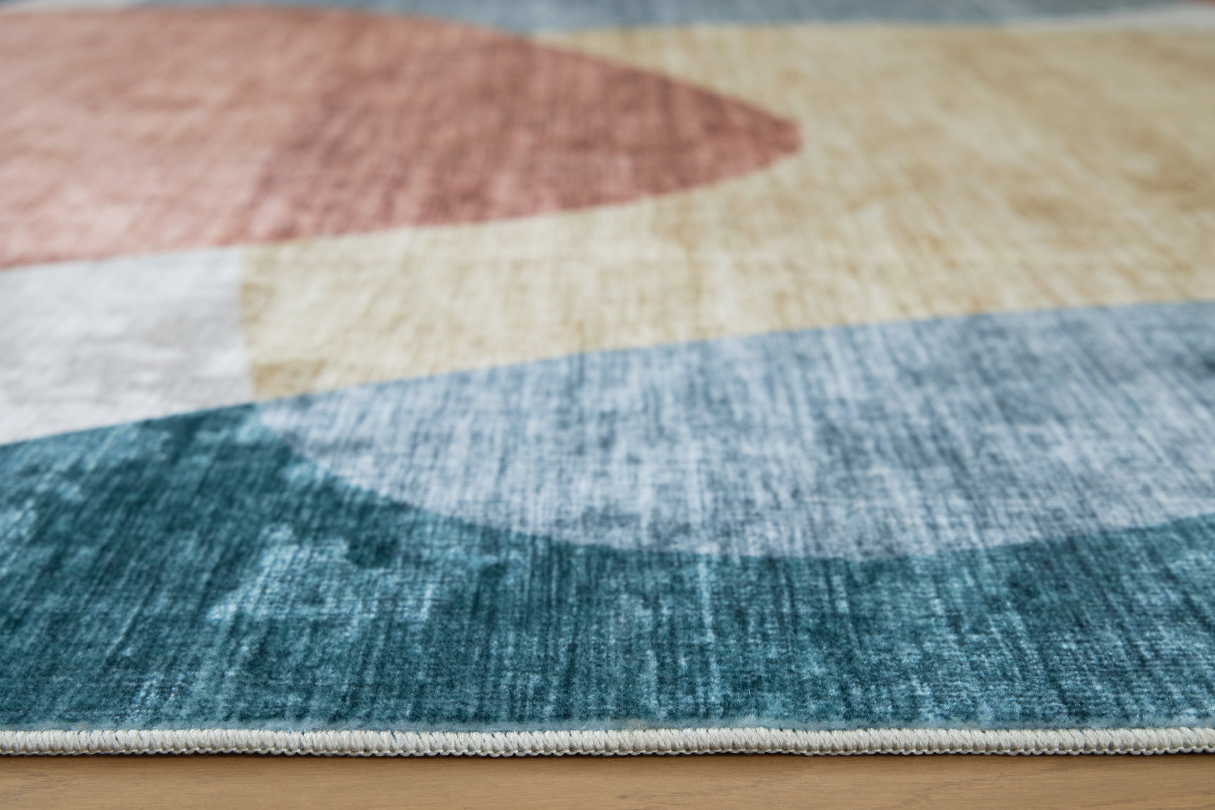 Chanleigh area rug rolled showing backing texture