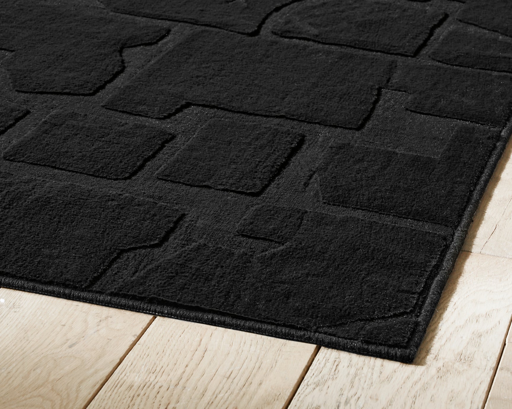 Detail view of machine woven high-low pile and backing