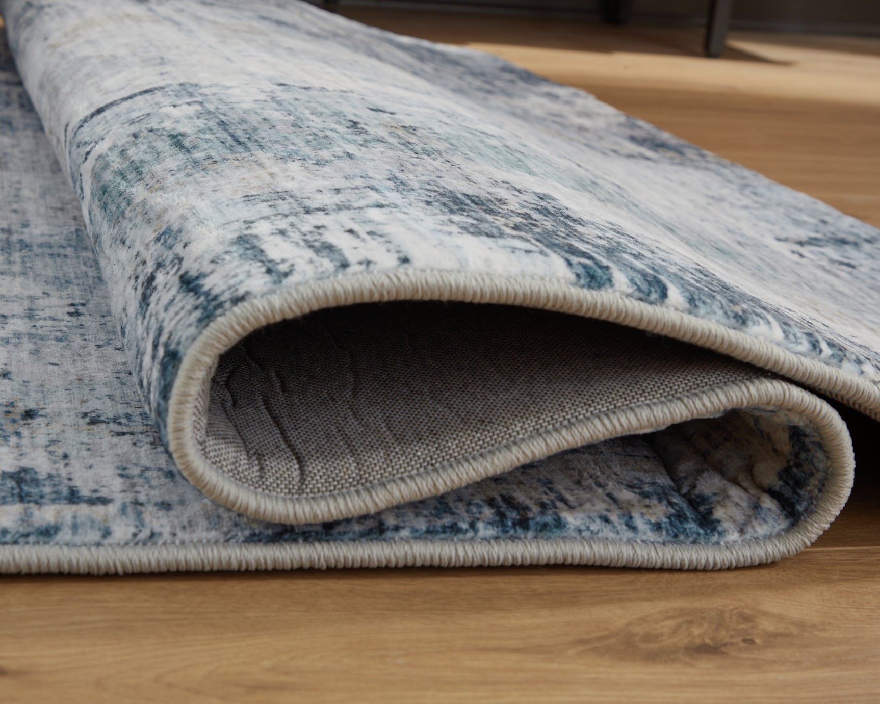 Rug rolled up showing backing and texture detail