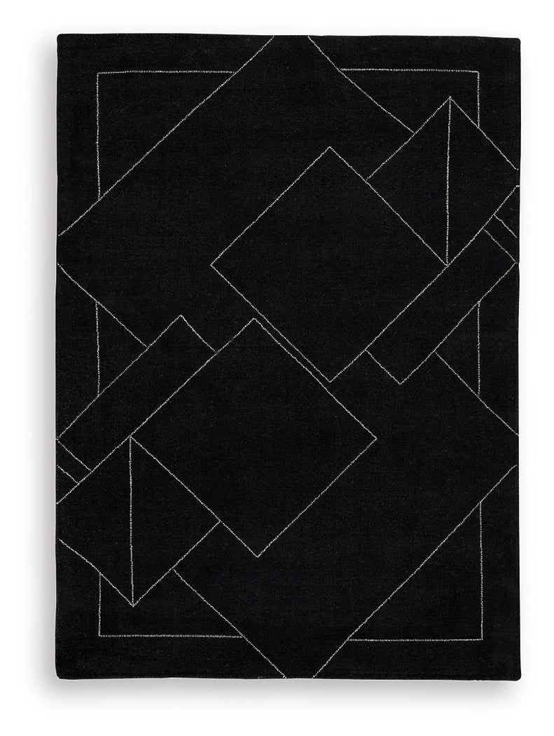 Close-up of Marav rug's hand tufted wool texture with black and white pattern