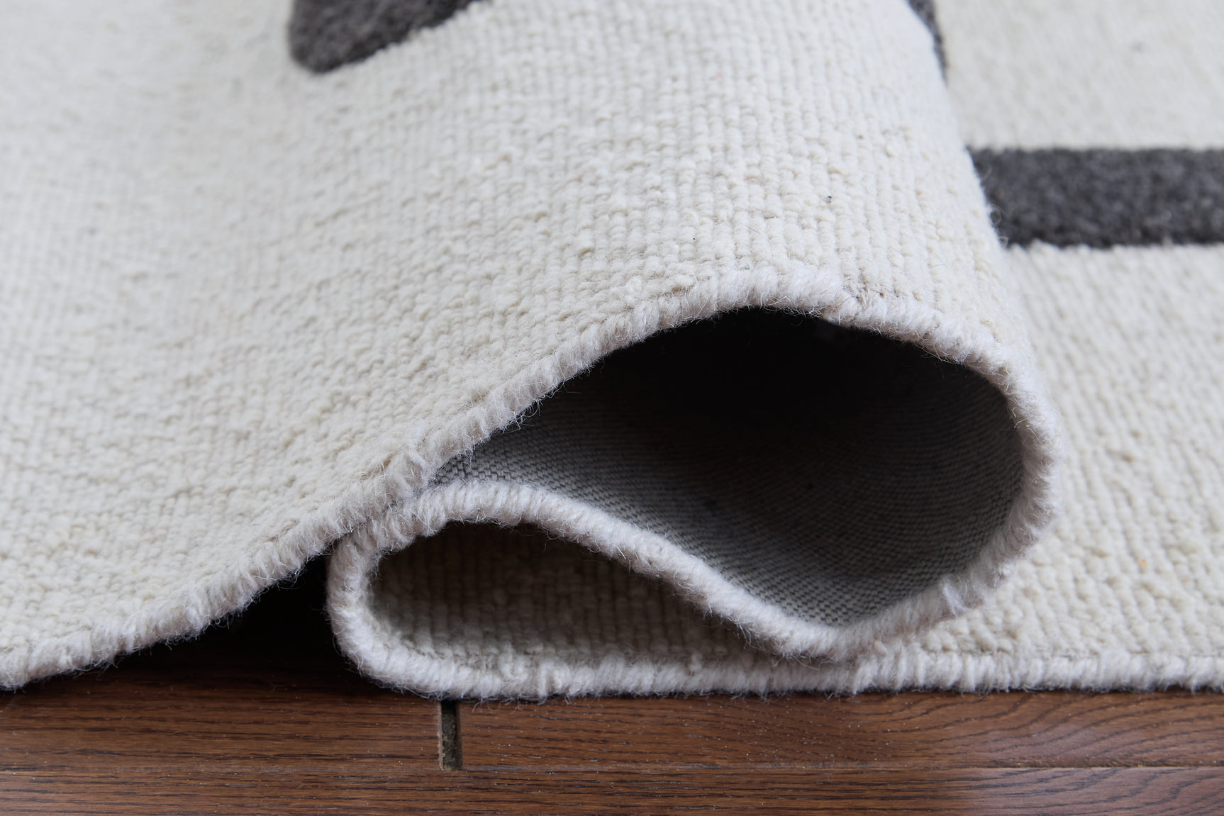 Rolled view of Davismour 5x7 area rug
