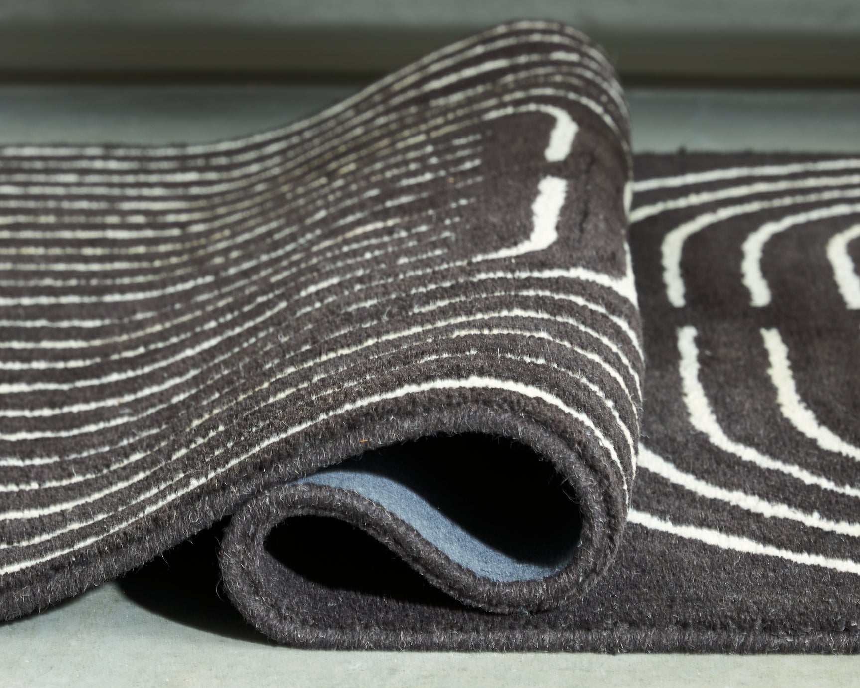 Rolled Eldonmore wool rug edge detail