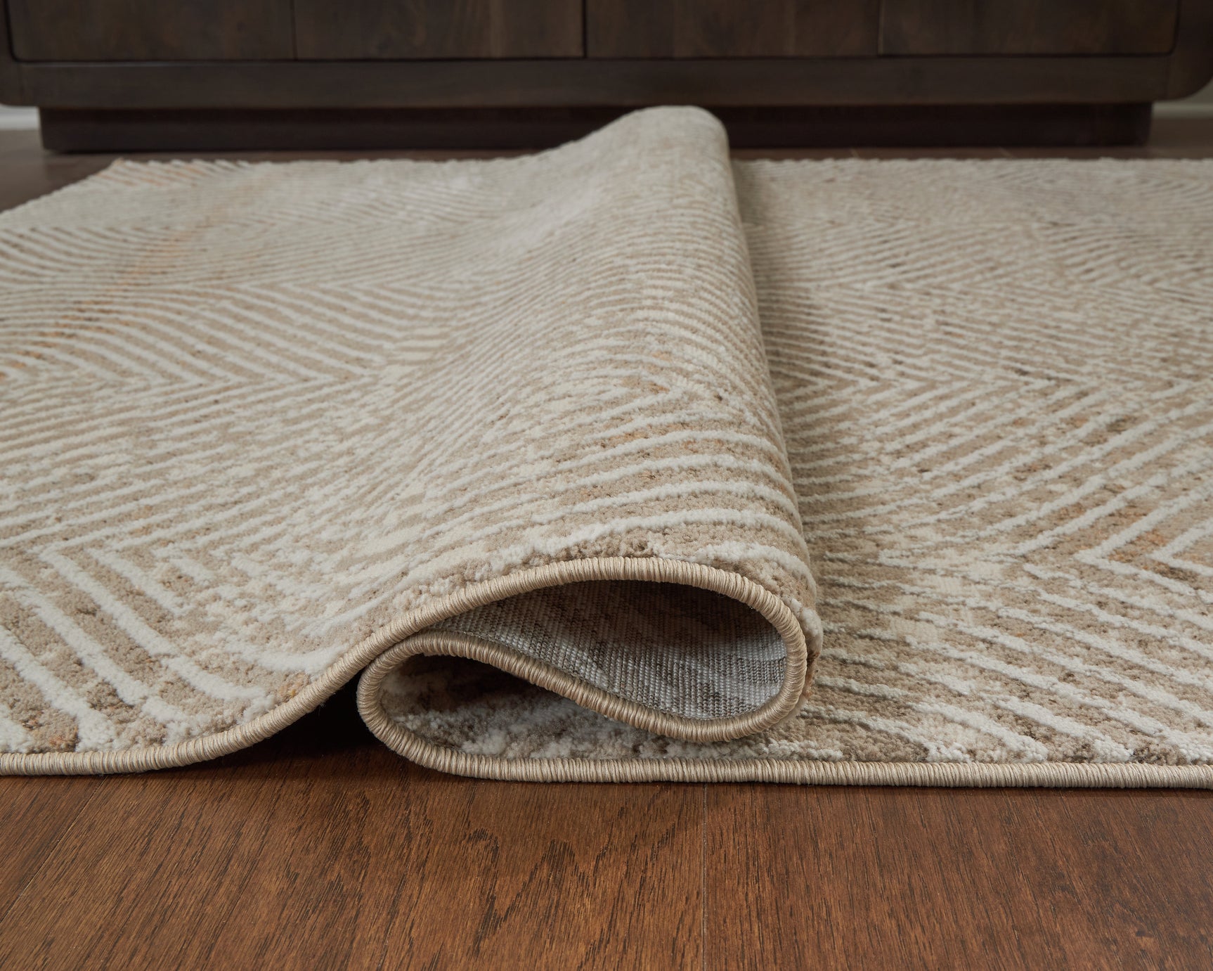 Bachus Multi area rug rolled showcasing pile thickness
